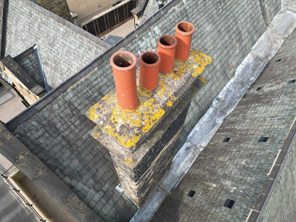 Aerial drone image of a residential roof with chimney pots, captured for detailed roof condition survey and inspection.