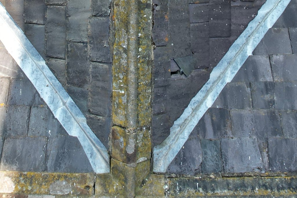Aerial drone image of a slate roof showing visible damage.