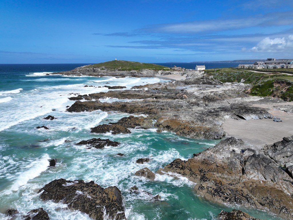 Professional aerial image of a coastline with breaking waves and sand taken with the DJI Mavic 3 Pro.