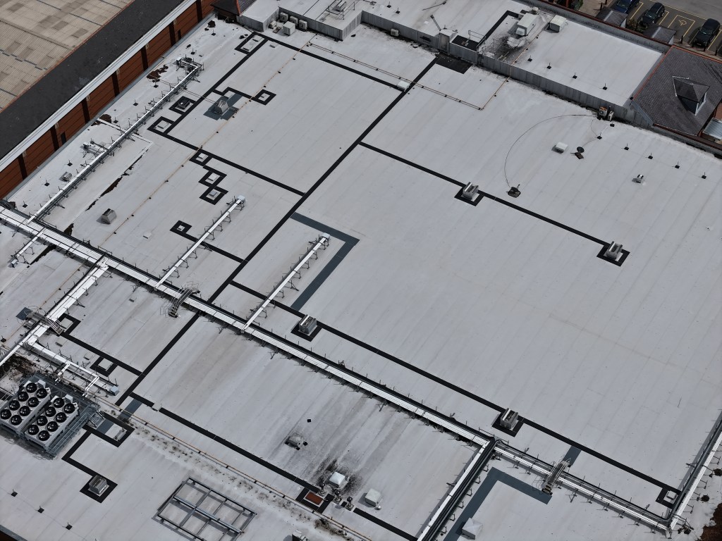 Flat roof commercial building in Leeds, West Yorkshire, captured during a detailed drone roof survey highlighting roof condition.