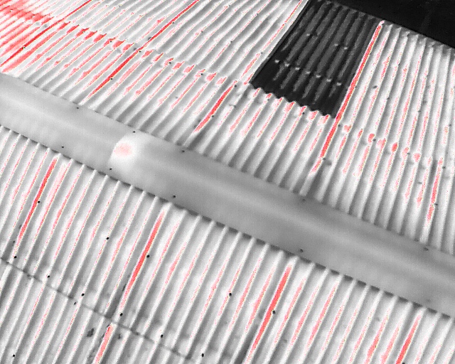 Aerial thermal image taken of a building showing various levels of moisture and thermal data. 