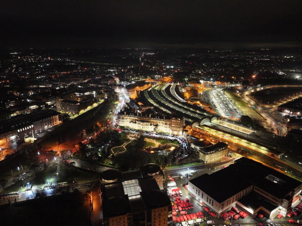Night aerial image of a city in the UK.
