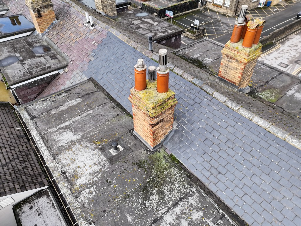 Aerial image showing a slate tiled roof for roof inspection purposes.